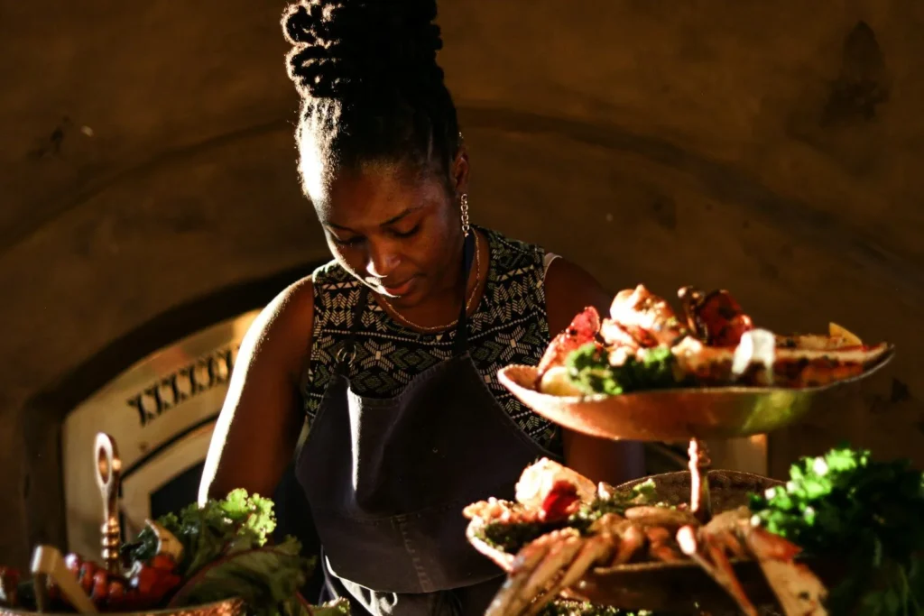 Caterer arranging platters of food for an event
