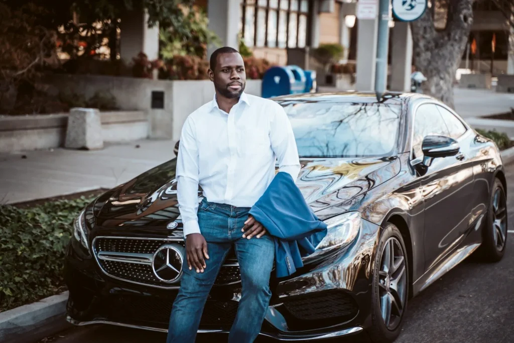 Man standing in front of a black Mercedes-Benz coupe