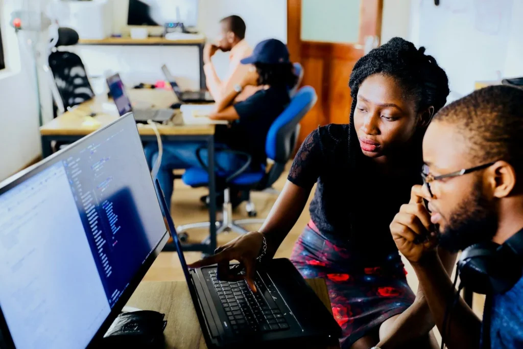 Small team working together around a computer in an office